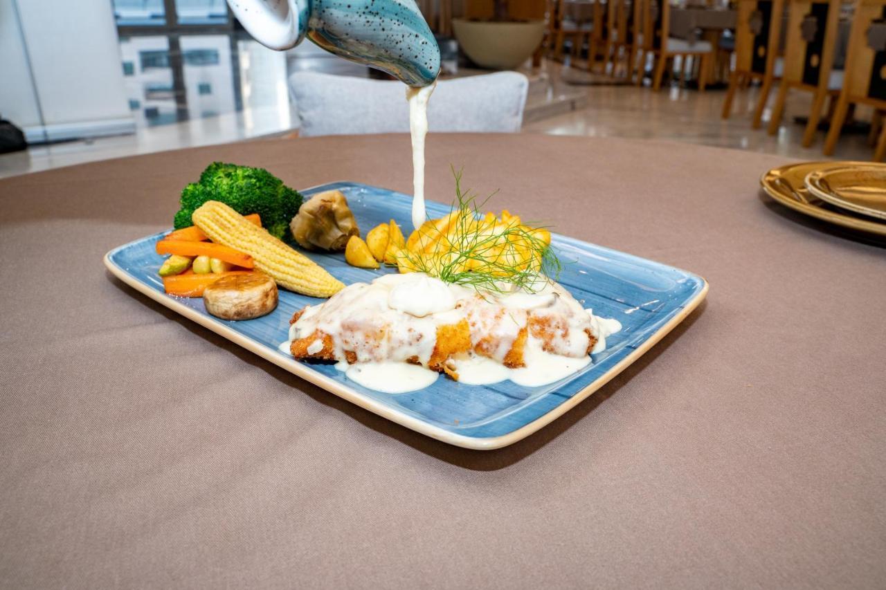 Luxe Grand Hotel Apartments Sharjah Eksteriør billede A plate of food being served